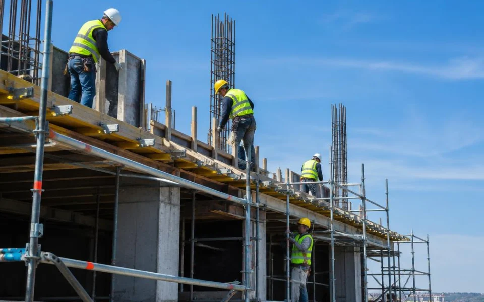 Construction workers on scaffolding at a building site