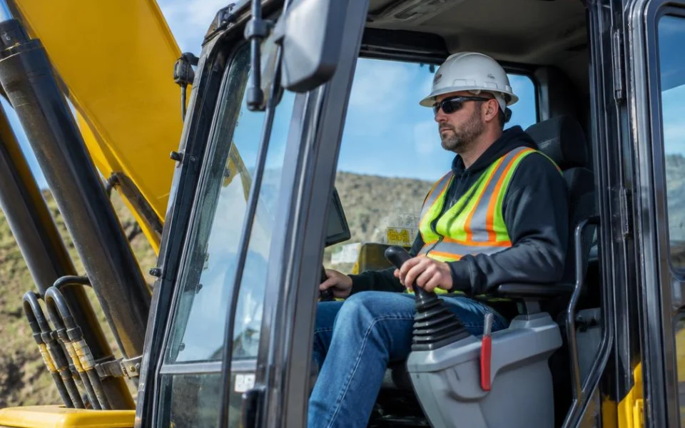 Machine operator at the controls of an excavator