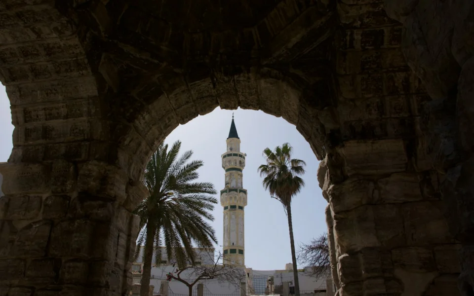 Minaret framed by a stone arch in Tripoli, Libya