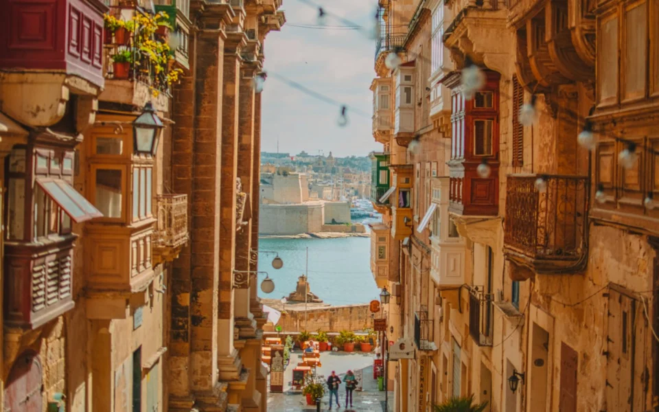 Narrow street with traditional balconies in Valletta, Malta