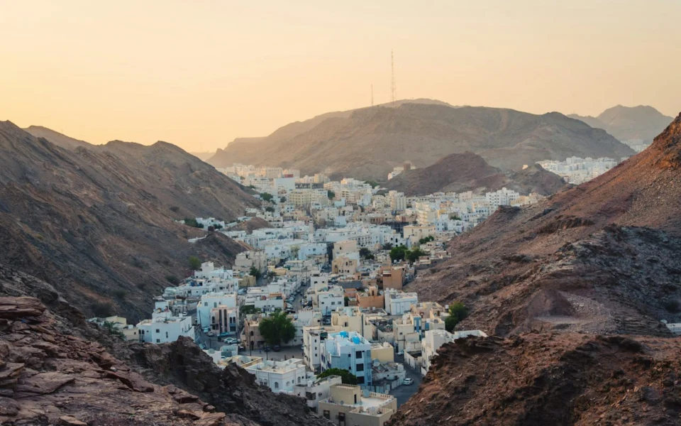 White buildings of Muscat between rocky mountains, Oman